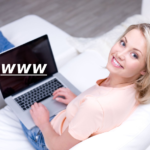 women on couch using laptop with www